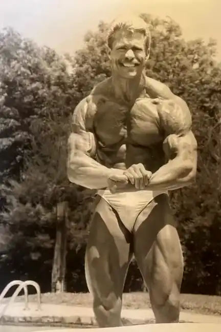 Jeff in the 1980s, posing by a pool. A photograph, animated.