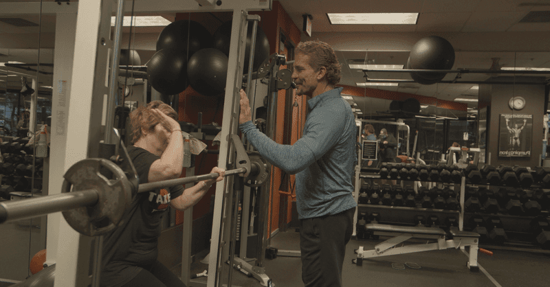 A client under the bar with Jeff at the rack